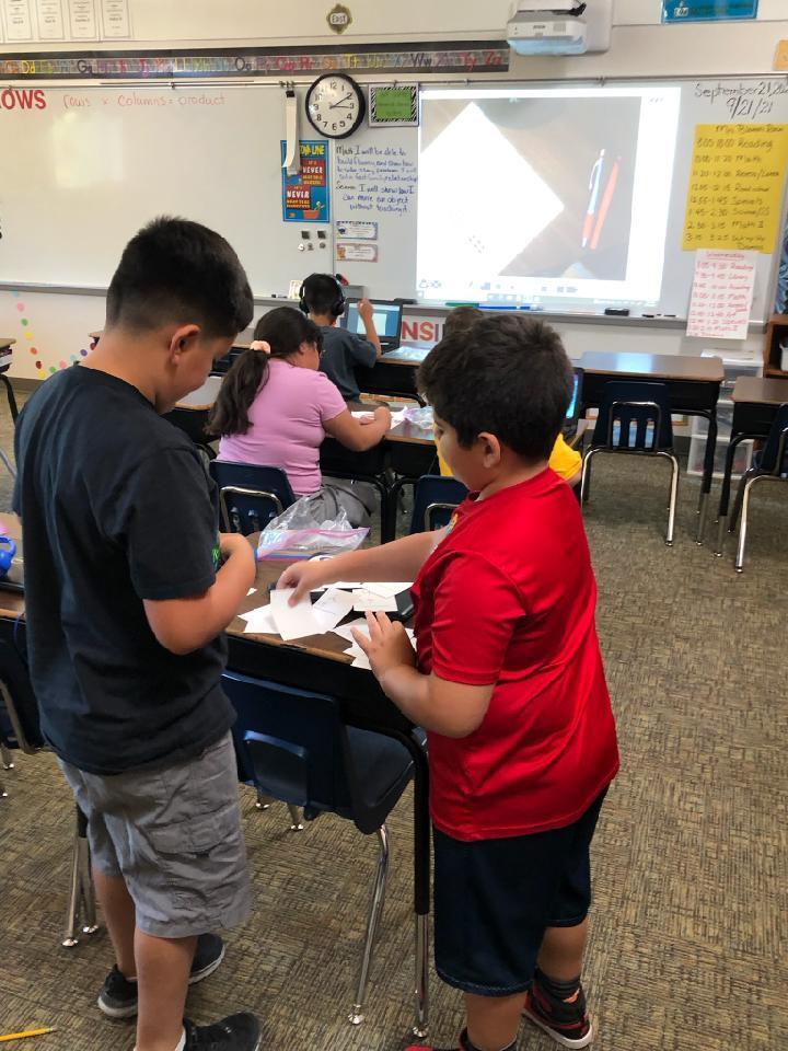 3rd graders teaming up to practice their math facts