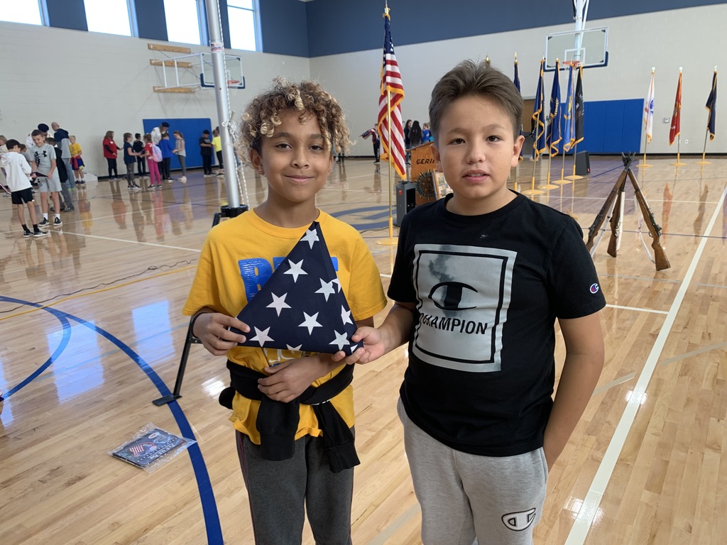 Displaying their folded American Flag